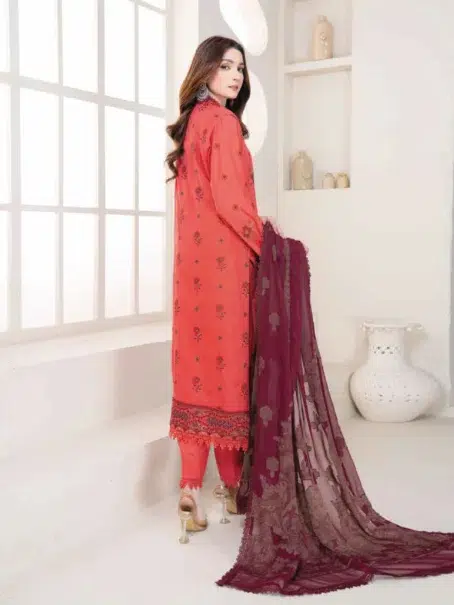 "Model styled in Anadil By Riaz Arts D-08 in Pastel Red color posed in an elegant outdoor setting."