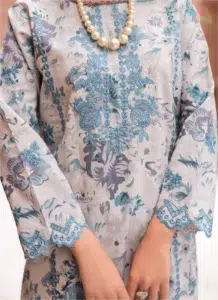 Close-up of Sanam Saeed by Puri Fabrics D-03 embroidery on lawn fabric with a focus on digital print and thread detailing.