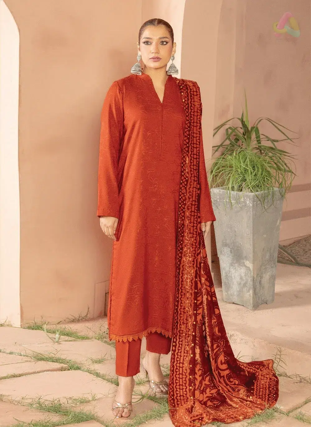 Anarkali By Mahay A-05 1 Anarkali By Mahay A-05 front view featuring fancy zarri jacquard peach shirt, plachi shawl, and plain trouser from Mahay Winter Collection.
